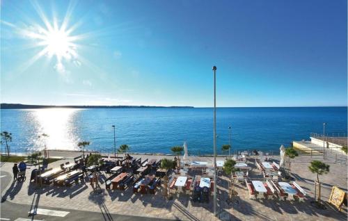 a view of the ocean with a lot of tables and chairs at Ocean Dream by Locap Group in Piran