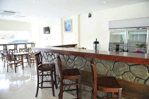 a bar in a restaurant with chairs and tables at Hallmark Express Hotel in Melaka