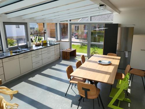 a kitchen with a table and chairs in a room at Family's Nest Chiemsee in Chieming