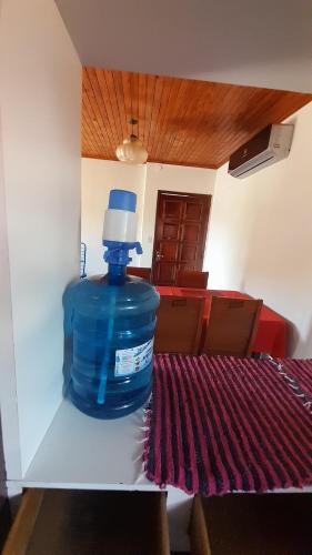 a large blue water bottle sitting on a table at AparWil in Encarnación