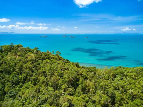 an island with trees and the ocean in the background at Villa E in Taling Ngam Beach