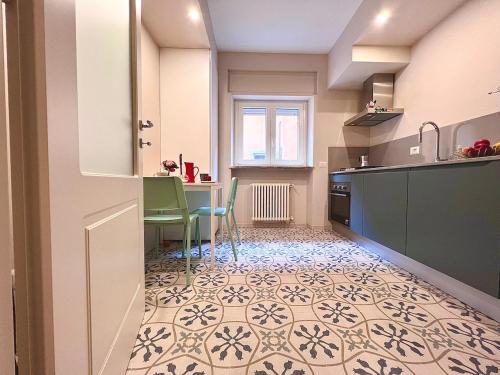 a kitchen with a table and chairs in a kitchen at Casa San Giusto in Lucca