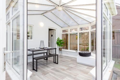 a conservatory with a glass ceiling and a table at Curlew - 3 Bedrooms Wi-Fi, Parking, Contractors in Thornton