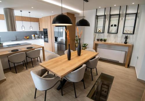 a kitchen and dining room with a wooden table and chairs at Casa Teo, By Hellocrete in Spílion