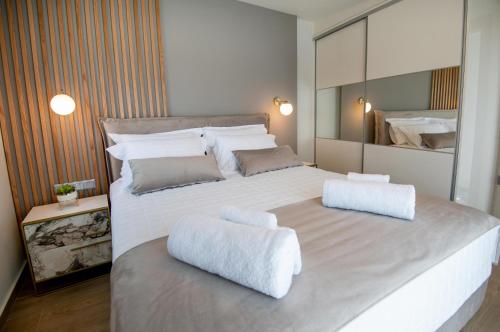a bedroom with a large white bed with two white seats at Casa Teo, By Hellocrete in Spílion