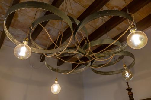 a chandelier with lights hanging from a ceiling at Sa Barcella TI 64 in Sineu
