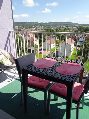 a table and chairs on a balcony with a view at Les tilleuls in Vittel