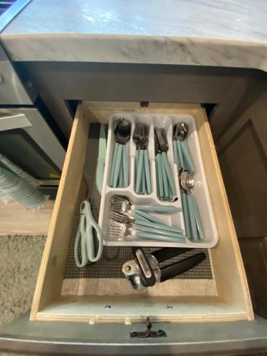 a drawer with utensils in a wooden box at Cozy RV Experience w/POOL+SPA Near Lake Conroe in Willis