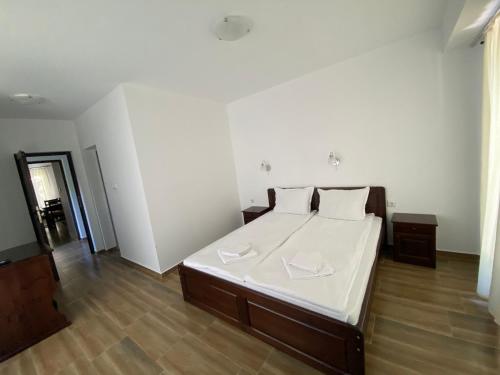 a bedroom with a bed with two napkins on it at Complex Magic of the Rhodopes in Bachkovo