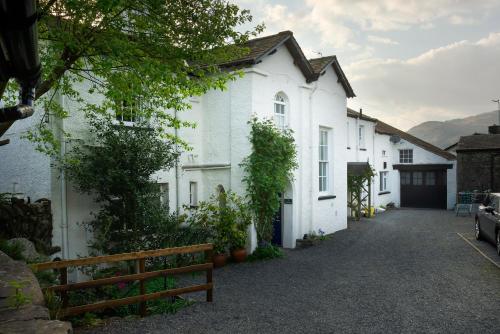a row of white houses with a driveway at 5 Lowfield, Ambleside in Ambleside