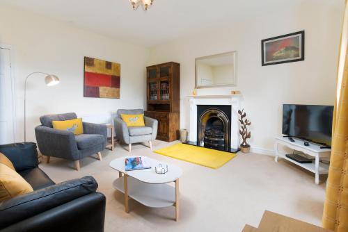 a living room with a couch and a fireplace at 5 Lowfield, Ambleside in Ambleside