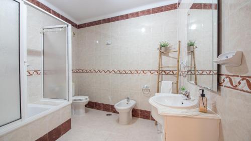 a bathroom with a sink and a toilet and a shower at Altura Vacations T2, Algarve in Altura