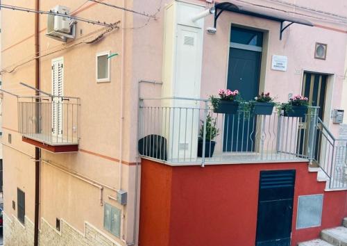 un edificio con macetas en un balcón en CASA VACANZE DIMORA MONFALCONE, en Montescaglioso