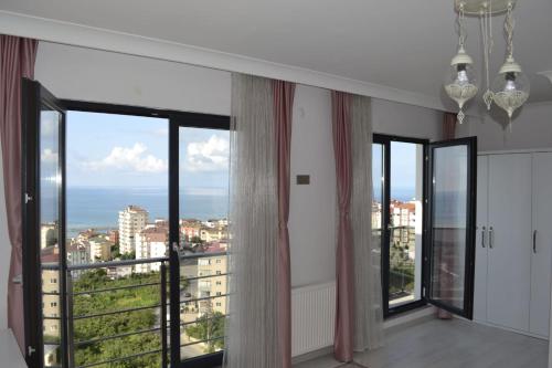 a room with large windows with a view of the ocean at Shahin Golden Hotel l الصقر الذهبي… in Bostancı