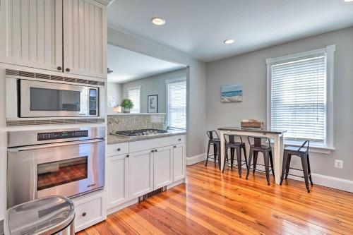 a kitchen with a table and chairs and a microwave at Mystic Refuge with Patio Less Than 1 Mi to Downtown! in Mystic