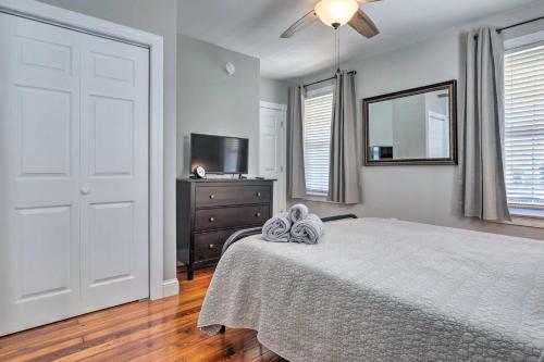 a bedroom with a bed and a dresser and a mirror at Mystic Refuge with Patio Less Than 1 Mi to Downtown! in Mystic