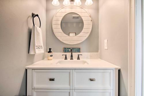 a bathroom with a white sink and a mirror at Walk to Maryland Beach Canal-Front Escape with Dock in Ocean City