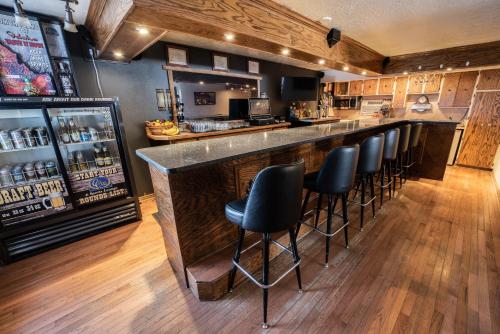 a bar with black stools in a restaurant at Clover Creek Inn in Montpelier