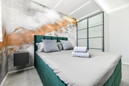 a bedroom with a large bed in front of a wall at Sigma Exclusive Apartment in Zadar