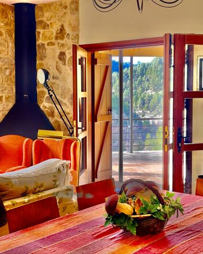 a room with a table with a basket of flowers on it at Torre del Marqués Hotel Spa & Winery - Small Luxury Hotels in Monroyo