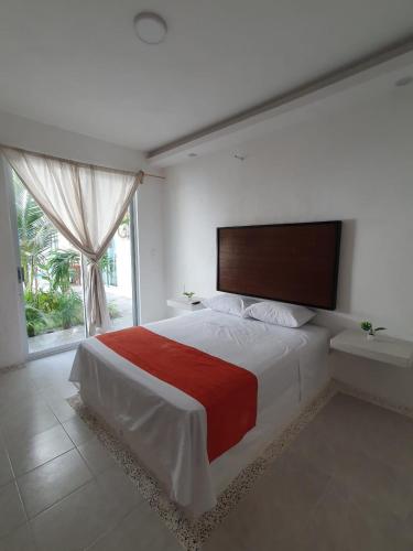 a bedroom with a large bed and a window at Riviera Bonfil in Acapulco