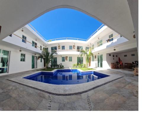an external view of a house with a swimming pool at Riviera Bonfil in Acapulco