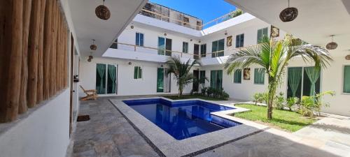 a house with a swimming pool and a courtyard at Riviera Bonfil in Acapulco