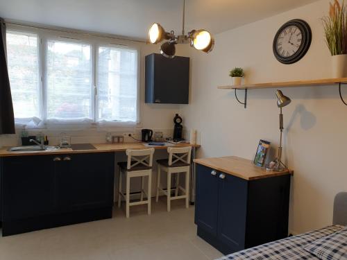 a kitchen with a desk and a sink and a counter at Le Gîte Senlisien in Senlis