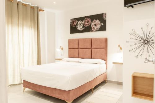 Säng eller sängar i ett rum på Apartamentos Kouohana
