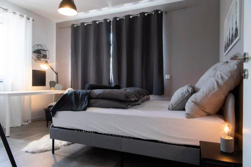 een slaapkamer met een bed met een zwart gordijn bij ☆ Stylisches Apartment in Gronau ☆ Direkt am St. Antonius-Hospital ☆ zentral gelegen in Gronau