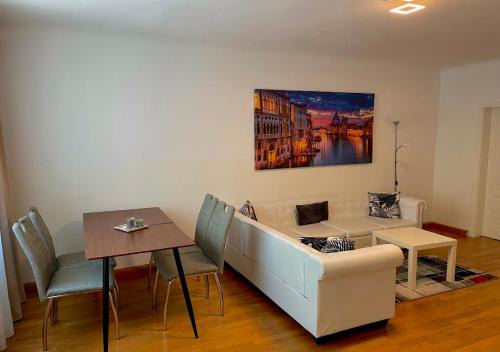 a living room with a couch and a table at Apartment Wien Mitte in Vienna