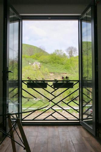 an open glass door with a view of a hill at Отель AuRoom Ванадзор in Vanadzor