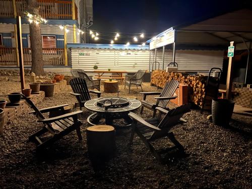 a group of chairs and a table in a yard at night at Mountain View Lodge in Red River
