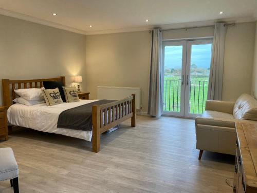 a bedroom with a bed and a sliding glass door at Executive home with plenty of room in Ely