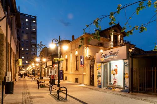 a city street at night with buildings and street lights at MariaApartments in Bitola