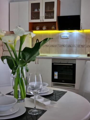a kitchen with a table with a vase of flowers at Harmony cozy home in Podgorica