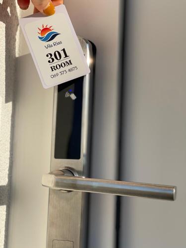 a door with a sign attached to it at Arial Penthouse Suites in Vlorë