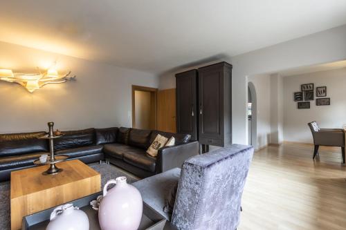 a living room with a couch and a table at Haus Almkreek in Kaprun