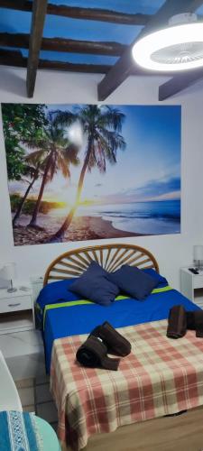 a bedroom with a bed with a painting on the wall at Casa Rural La Fuensanta in Mojácar