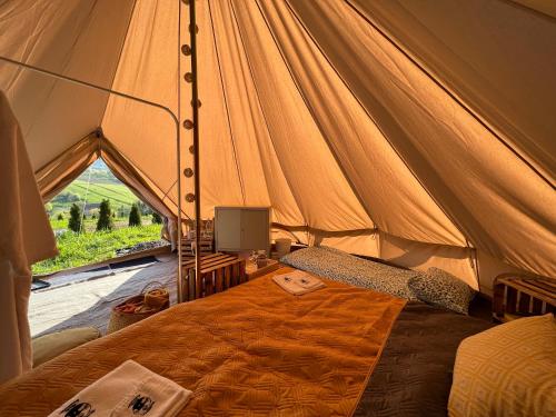a bedroom with a bed in a tent at Glamping Bieszczady z basenem in Solina