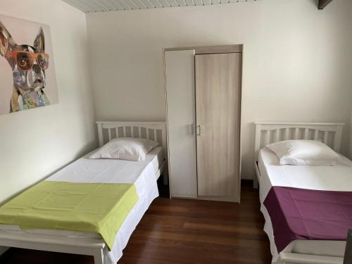 a bedroom with two beds with colorful sheets at SPACIEUX T5 in Kourou