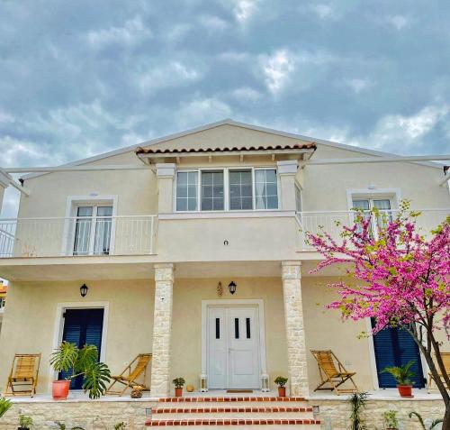 a large white house with a balcony at Tani's House in Sarandë