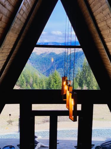 a view from a room with a table and a window at Nordik Cabin - Aframe with 2 bedrooms in Mărişel