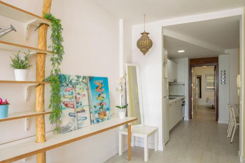 a hallway of a home with white walls and wooden shelves at La casita de Matilda, 1A in Las Palmas de Gran Canaria