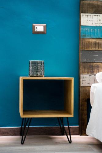 a side table in front of a blue wall at Adrian's B&B in Turi