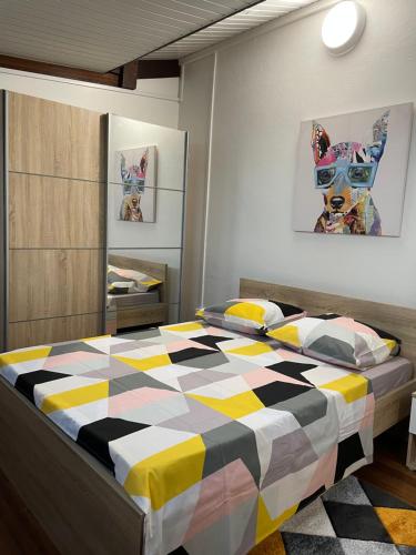 a bedroom with a bed with a checkered blanket at CHARMANT T2 in Kourou