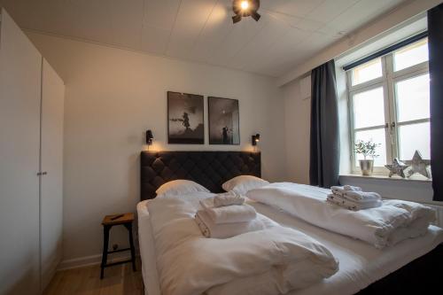 a bedroom with two beds with white towels on them at Central City Apartment in Sønderborg