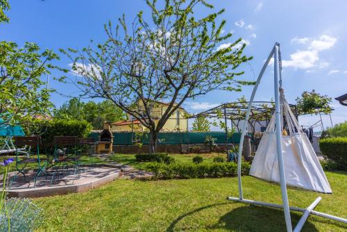 a playground in a park with a swing at Apartments Villa Bare in Kastav