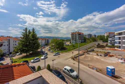 a city street with cars parked in a parking lot at Apartments Villa Bare in Kastav