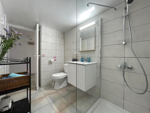 a bathroom with a shower and a toilet and a sink at Krasas Beach in Larnaka